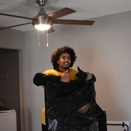 Pantheon Moving crew member wrapping furniture in protective materials in Kansas City