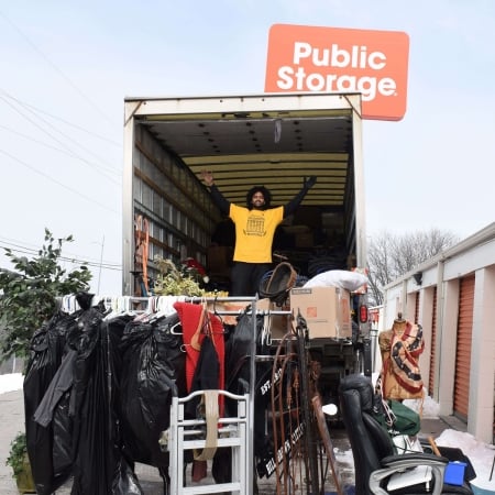 Pantheon Moving crew carrying large furniture items from a moving truck in Kansas City