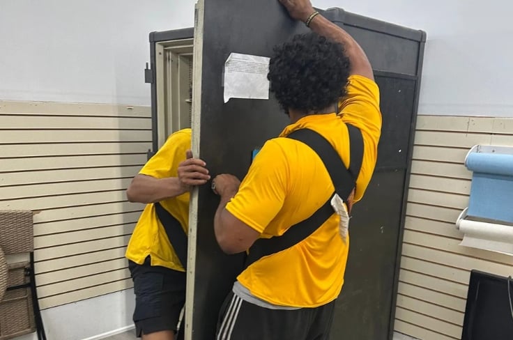 Pantheon Moving crew member carrying a large heavy item during a Kansas City move